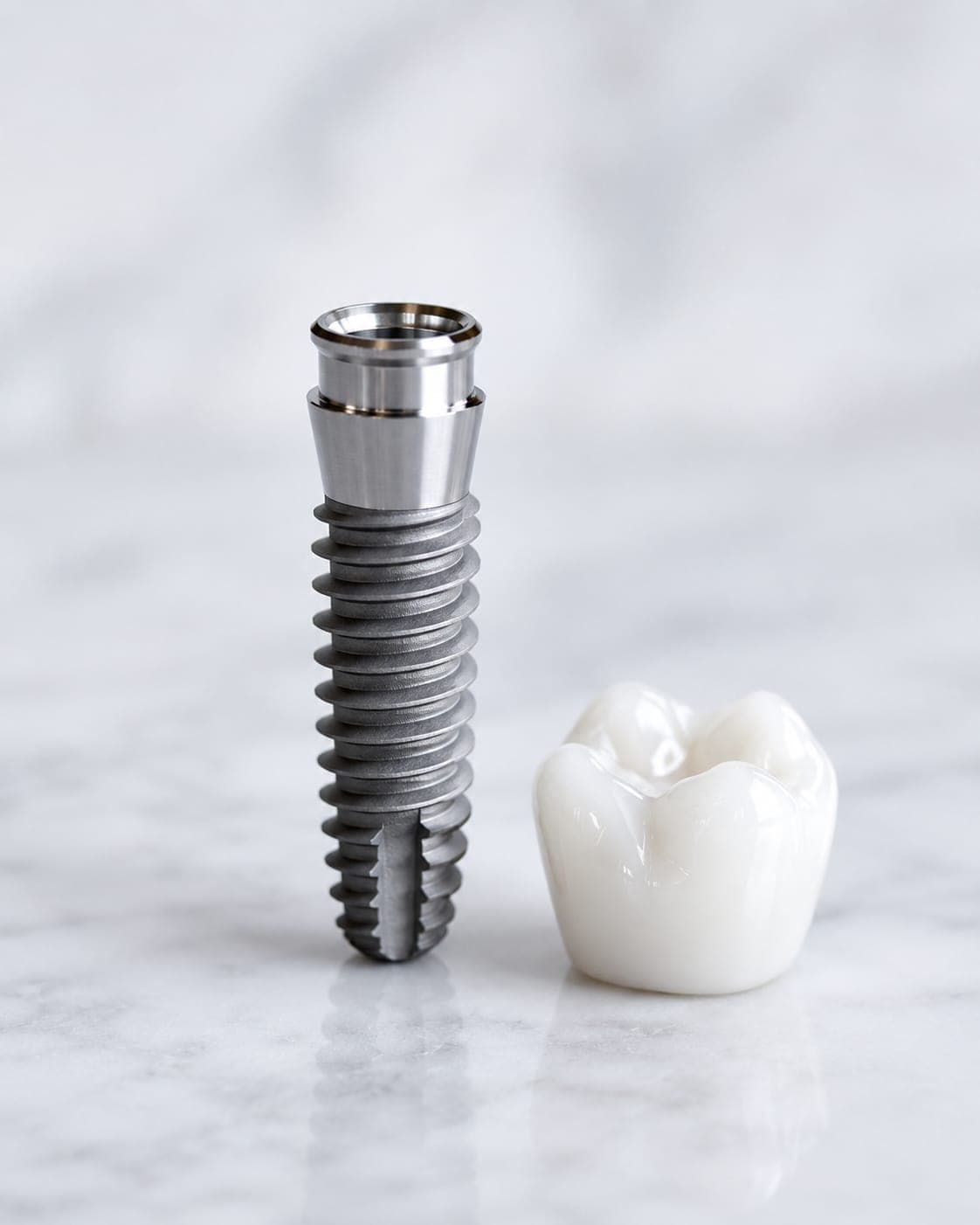Implants — a titanium post beside the ceramic crown that seats on it