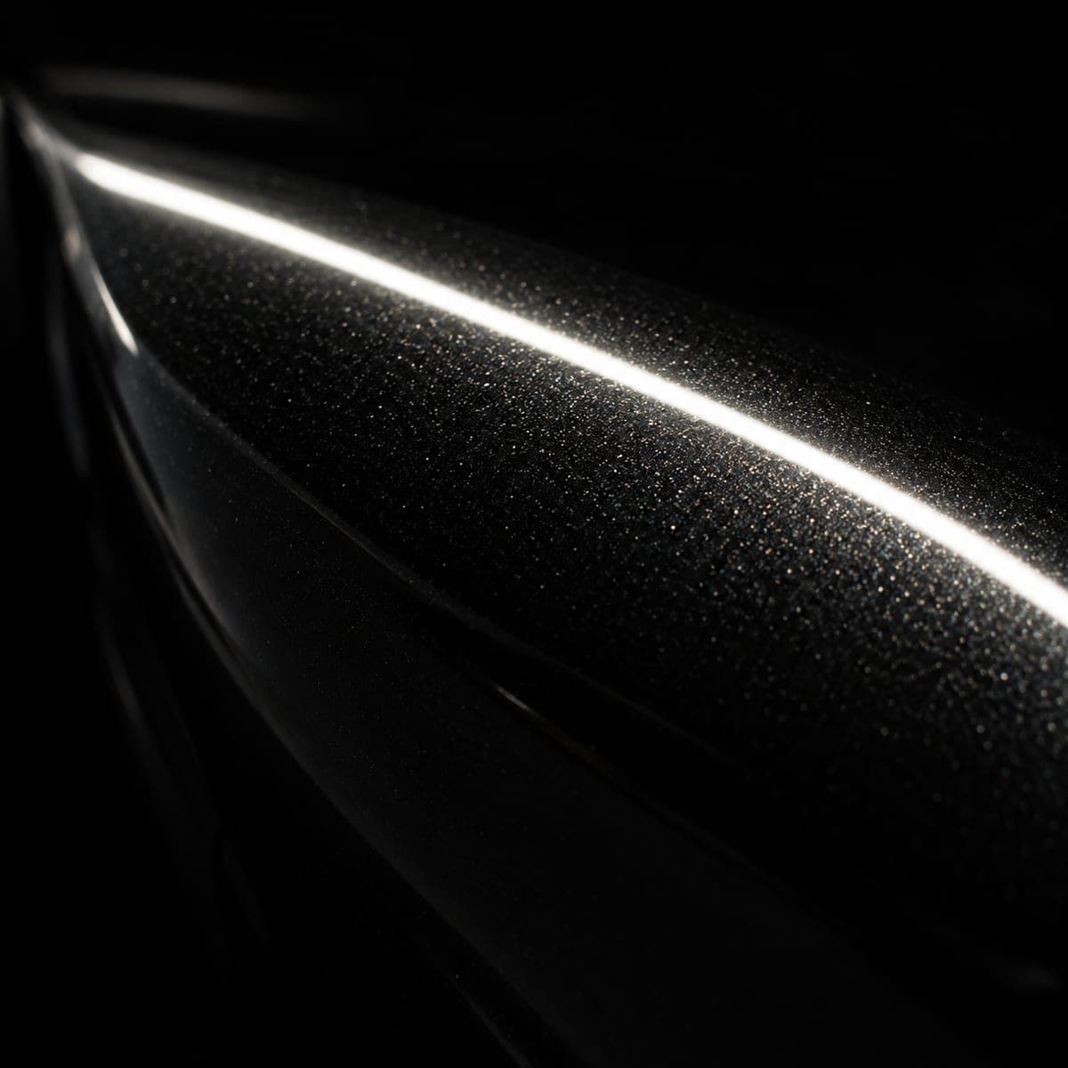 A macro photograph of Nero Noctis paint under the line