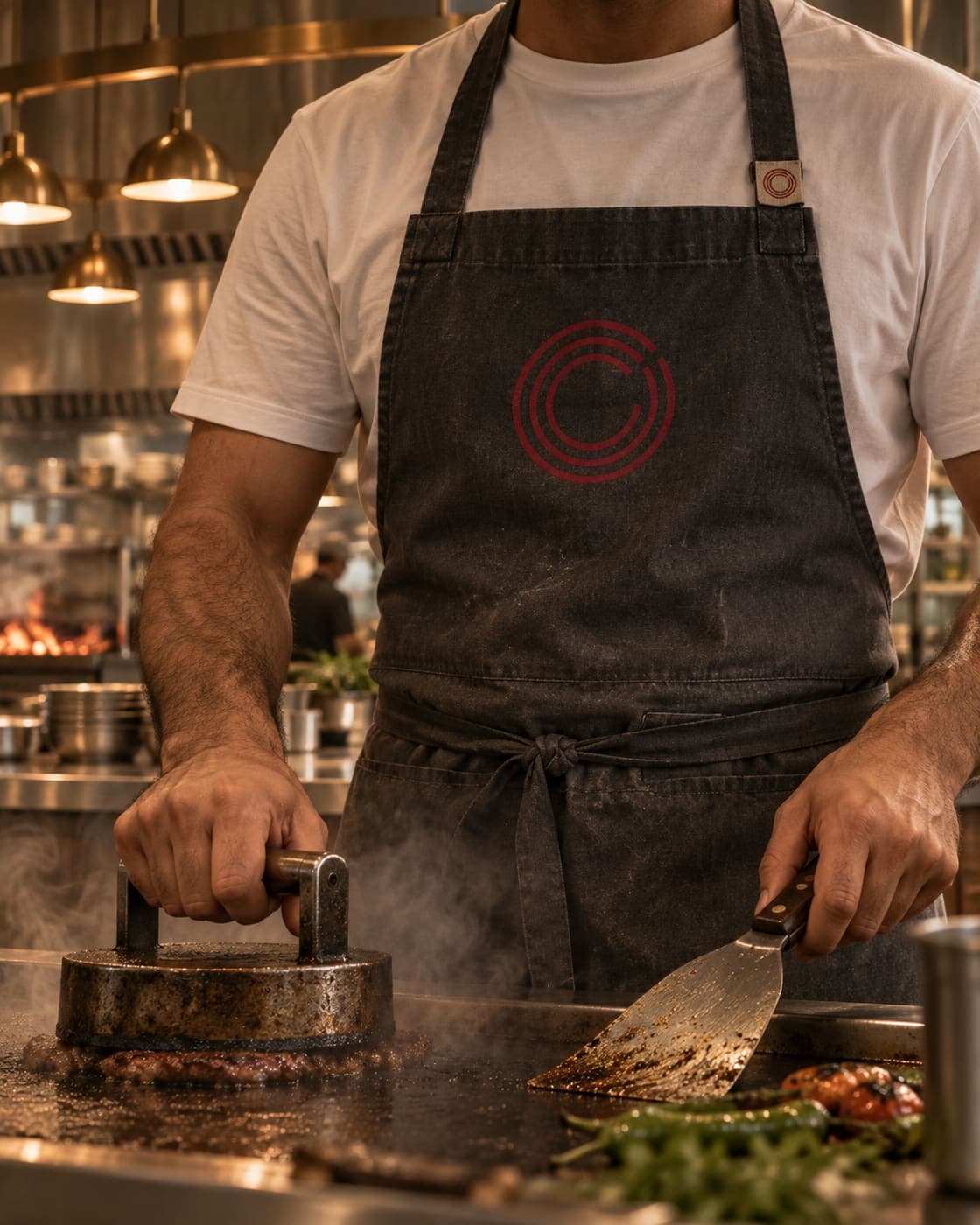 The apron. The ring on the chest.
