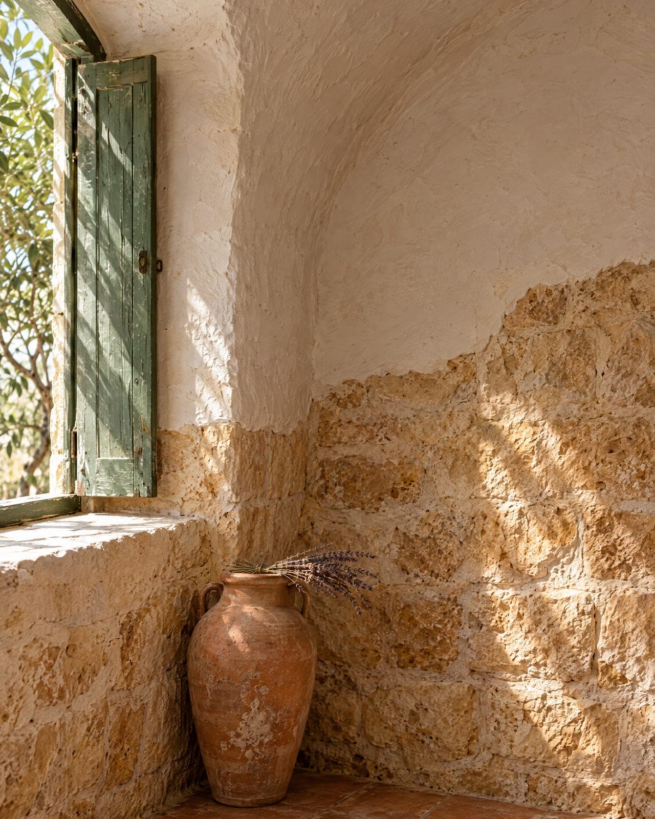 Where the whitewashed vault meets the old stone wall — the ground floor as it was built in 1890.